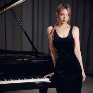 Cathryn Li posing next to a baby grand piano. Photo from Facebook.