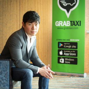 Tan posing with a GrabTaxi banner.