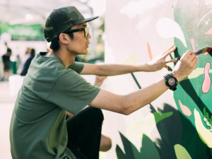 Deon Phua illustrating a mural as part of Tell Your Children.