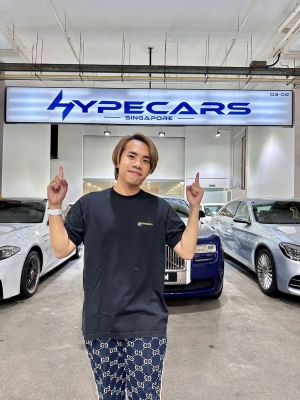 JianHao Tan in front of his car dealership, HypeCars, in Bukit Batok.