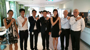 Chaly Mah (centre) pictured with Deloitte executives and Deloitte athletes in July 2015.