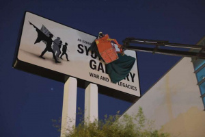 Workers covering the Syonan Gallery signboard